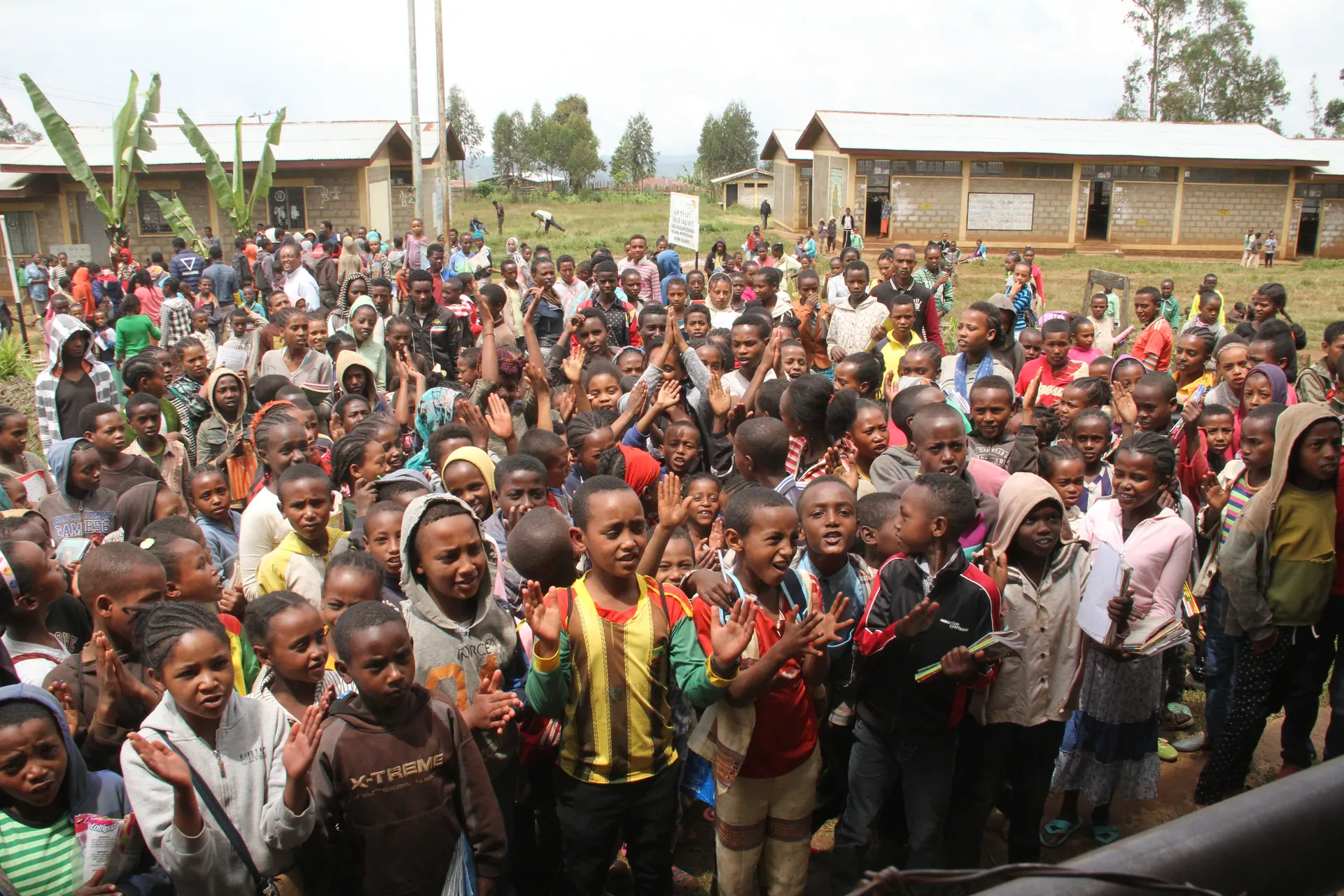 A crowd of children around the bus in Dilla