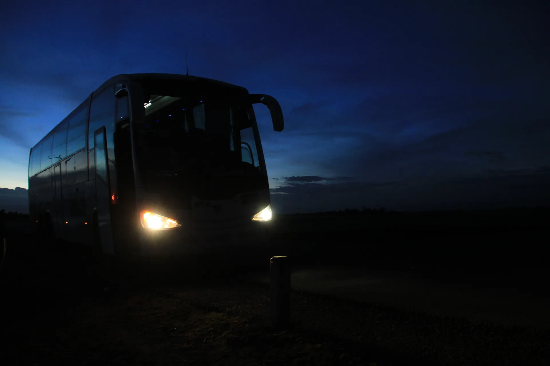 The Astrobus at dusk, headlights on