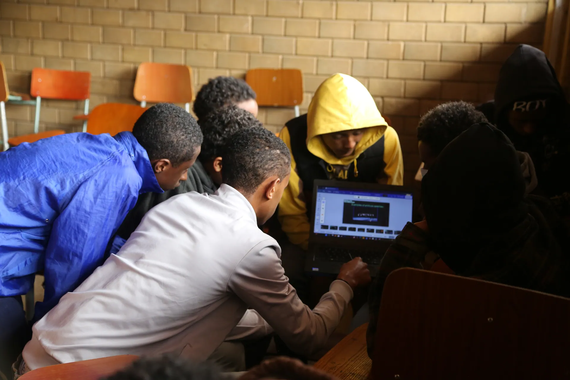 Trainees gather round a laptop