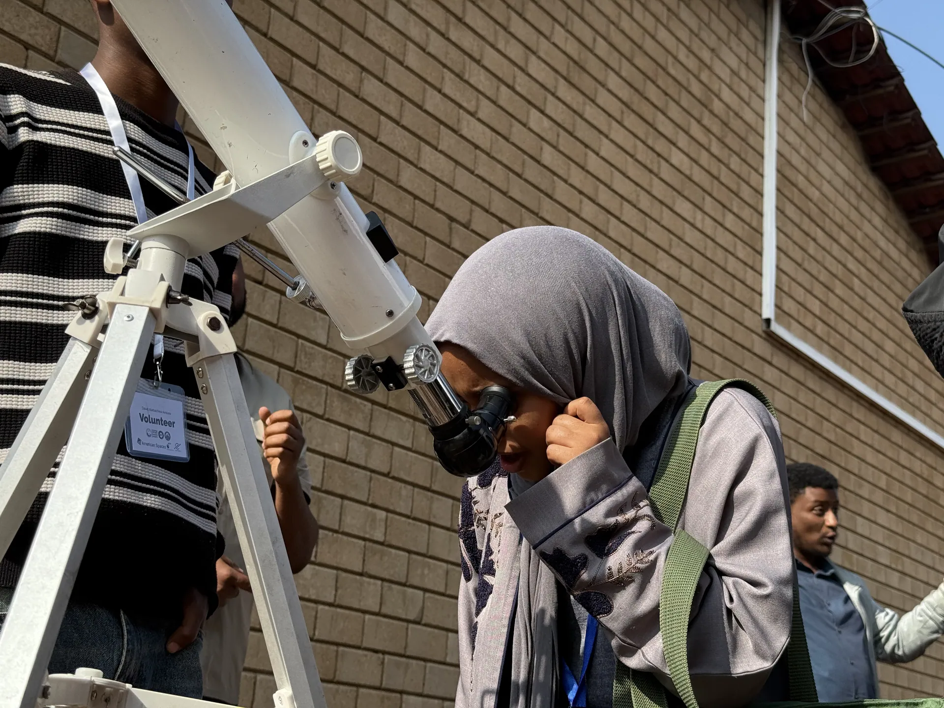A trainee looks through a telescope