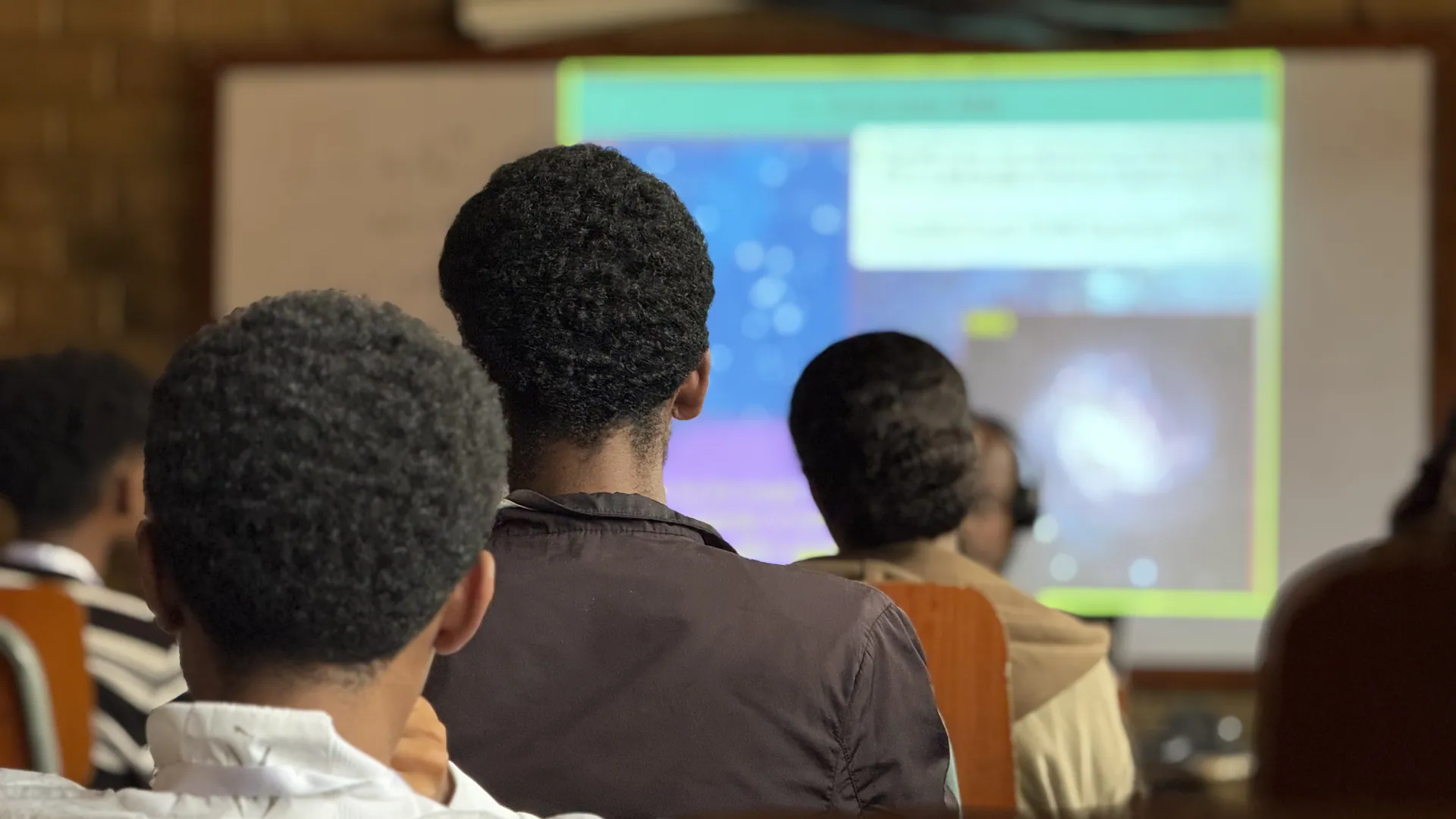Trainees watch a slide of a spiral galaxy